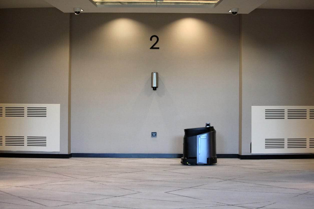 Empty corridor with a cleaning robot in a modern building.