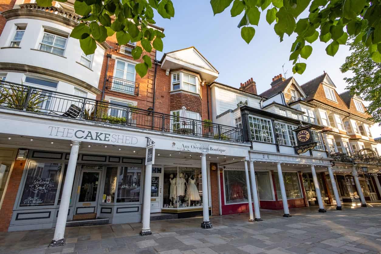 Charming street view of The Cake Shed boutique shop with white facade and large windows.