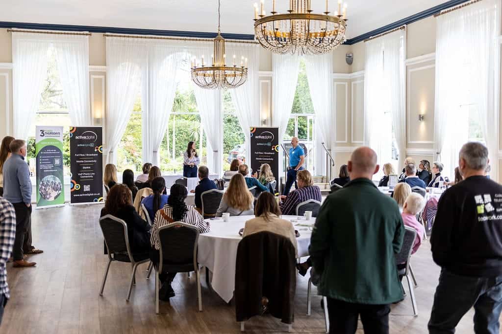Audience listening to speakers at The Spa Hotel during a chamber event.